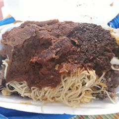A picture of Spagetti with tomato sauce.