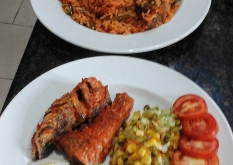 Jollof Rice peppered glazed fish and corn veggies Jollof Rice peppered glazed fish and corn veggies