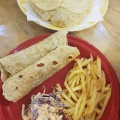 A picture of BBQ chicken with homemade tortillas.