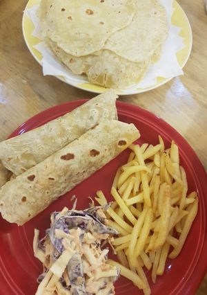 A picture of BBQ chicken with homemade tortillas.