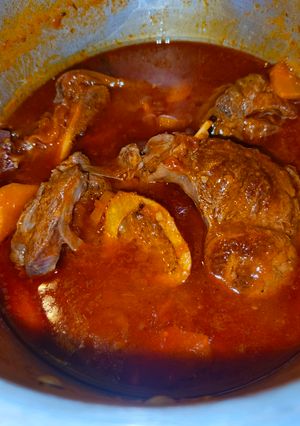 A picture of Beef Stew with Carrots and tomatoes.