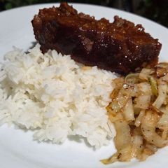 A picture of The BEST Meatloaf with sauteed cabbage.