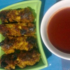 A picture of Barbequed Chicken wings with Chilli Sauce.