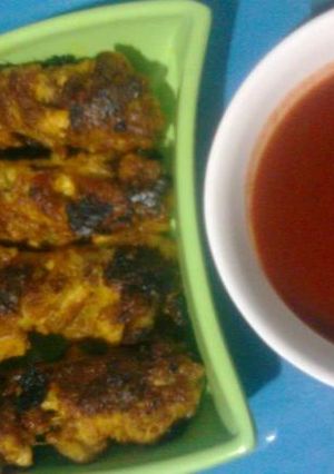 A picture of Barbequed Chicken wings with Chilli Sauce.