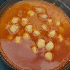 A picture of White chana with onion and tomato gravy.