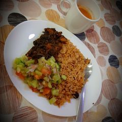 A picture of Palak chicken with brown rice.