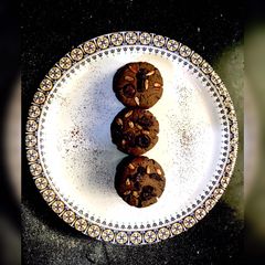 A picture of Dark Chocolate cookies with Chocochips and berries on top.
