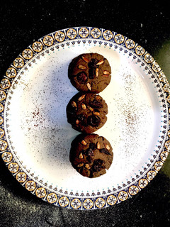 A picture of Dark Chocolate cookies with Chocochips and berries on top.