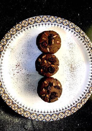 A picture of Dark Chocolate cookies with Chocochips and berries on top.