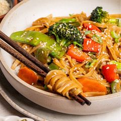 A picture of Stirfry vegetables and rice noodles.