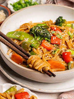 A picture of Stirfry vegetables and rice noodles.