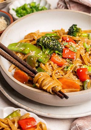 A picture of Stirfry vegetables and rice noodles.