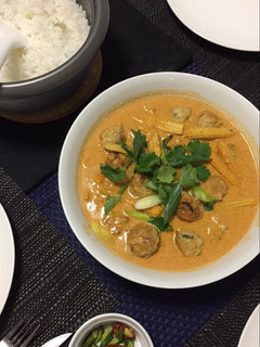 A picture of Chicken meatball in thai red curry sauce.
