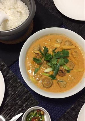 A picture of Chicken meatball in thai red curry sauce.