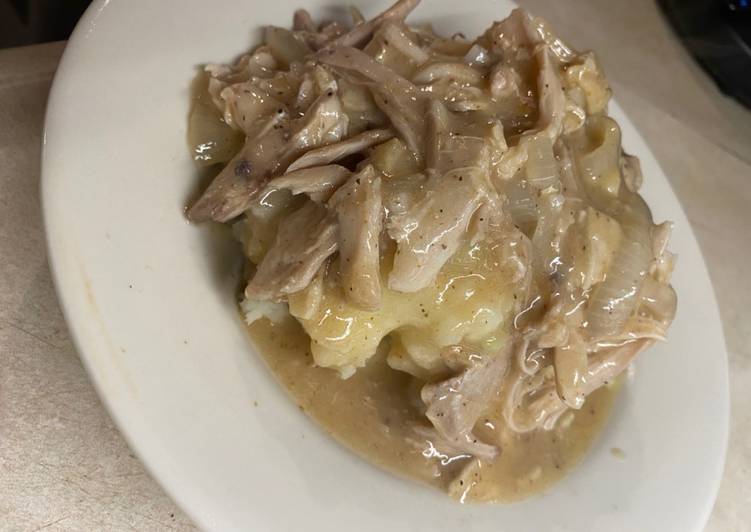 Shredded chicken and gravy over mashed potatoes