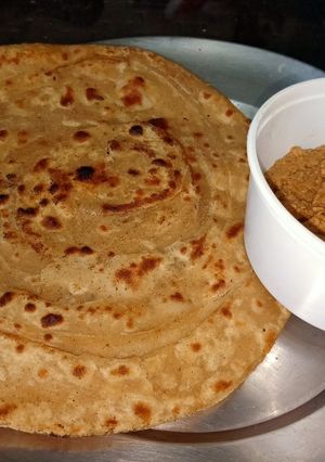 A picture of Lachcha paratha with wheat flour and til lahsun chutney.