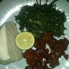 A picture of Fried beef and steamed sukuma wiki.