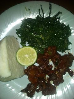A picture of Fried beef and steamed sukuma wiki.