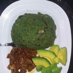 A picture of Mukimo served with fried beef and avocado.