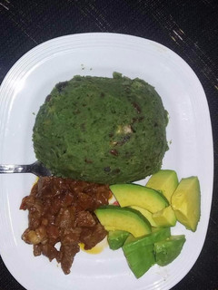 A picture of Mukimo served with fried beef and avocado.