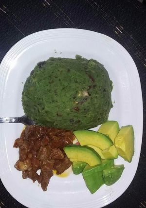 A picture of Mukimo served with fried beef and avocado.