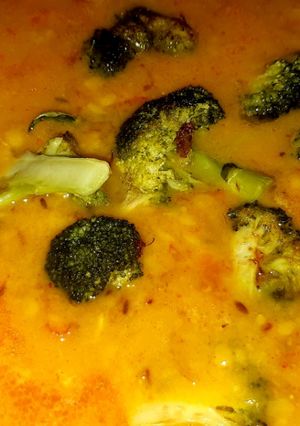 A picture of Broccoli with yellow lentils.
