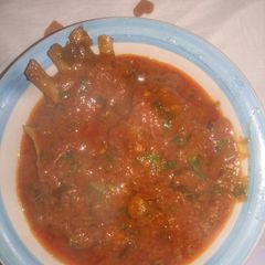 A picture of Fresh tomatoes and goat meat.