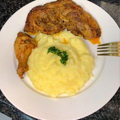 A picture of Butter fried pork shank & creamy potato mash.