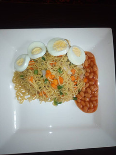 A picture of Veggies noodles with baked beans and egg.