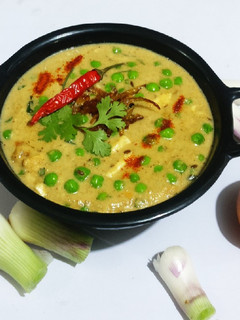 A picture of Mutter paneer in yellow capsicum & methi gravy.