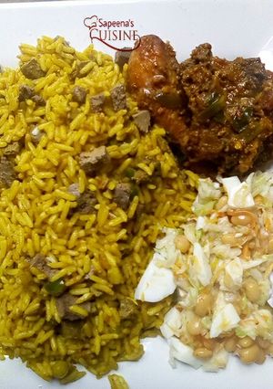 A picture of Fried rice with pepper chicken and Coleslaw.