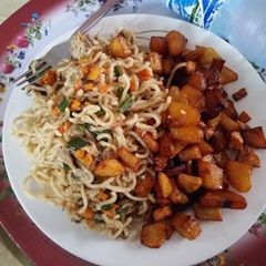 A picture of Fried Indomie with fried Plantain and Irish potatoes.