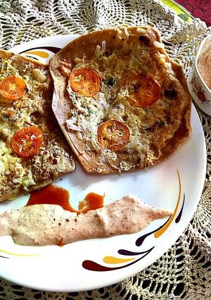 A picture of Egg Cheese Paratha with curd.