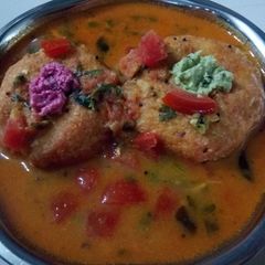 A picture of Tomato rasam vada.