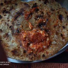 A picture of Paratha with chutney.