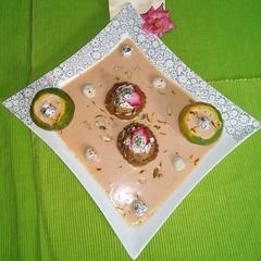 A picture of Orange Makhana Rabdi with stuff Mawa Kachori.