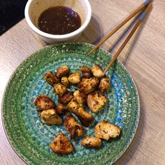 A picture of Spicy chicken bites with a honey mustard sauce.