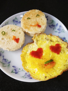 A picture of Emoji Omelette with bread toast.