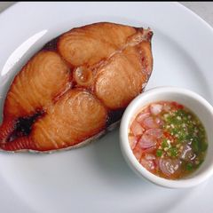 A picture of Grilled fish with okro sauce.