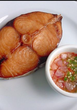 A picture of Grilled fish with okro sauce.