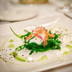 A picture of 65ºC / 149ºF slow cooked egg with salmon rocket salad.