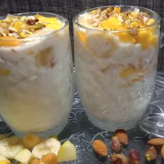 A picture of Yoghurt Nuts and fruit for breakfast.