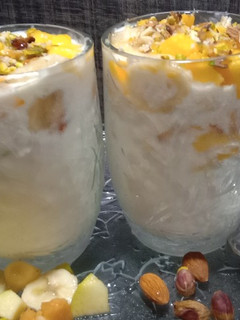 A picture of Yoghurt Nuts and fruit for breakfast.