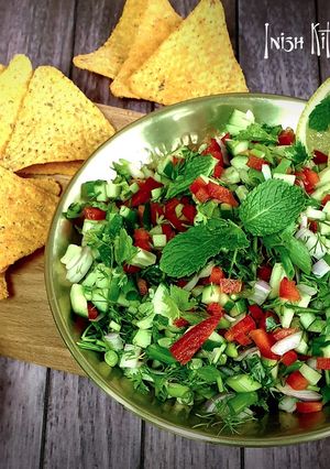 A picture of Cucumber Salsa with Tortilla Chips.