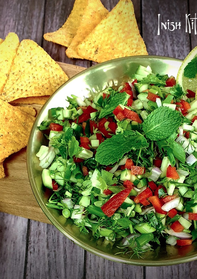 A picture of Cucumber Salsa with Tortilla Chips.