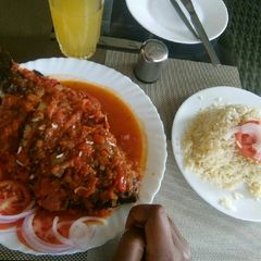 A picture of Wet fried tilapia served with rice.