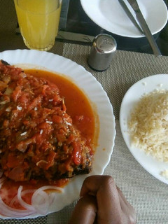 A picture of Wet fried tilapia served with rice.