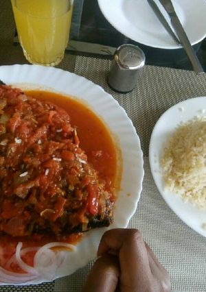 A picture of Wet fried tilapia served with rice.