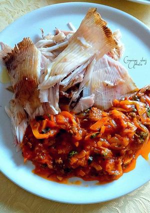 Una foto de Pez raya a las brasas acompañado con salsa de tomates