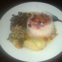 A picture of Fried rice withbeef stew and black beans.